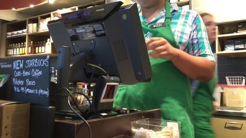 COQUITLAM , British Columbia , Canada - 09 02 2016: Coquitlam, BC, Canada - September 02, 2016 : Customer buying coffee and paying by apple pay at Starbucks with 4k resolution.