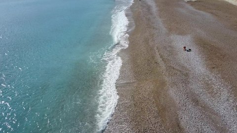 Aerial Pan Up Clean, Sunny, Quiet, Mountain Beach Konyaalti Plaj Antalya Turkey (Drone - 4K)