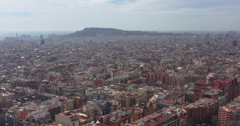 aerial image of barcelona with left pan revealing sagrada familia church