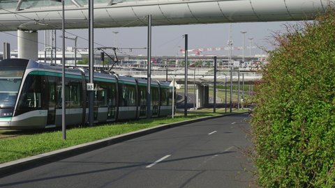 Orly , Ile de France , France - 02 14 2021: Modern metro shuttle and car drive in opposite directions at Paris Orly airport