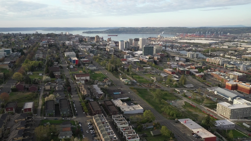 Cinematic 4K aerial drone dolly footage of the downtown commercial and waterfront area of Tacoma, a city near Seattle in Western Washington, Pacific Northwest, the economic center of Pierce County