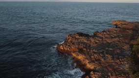 Fishermans fishing on small rock cliff on sunset half circle video Nusa Dua Bali Indonesia. High quality 4k aerial footage
