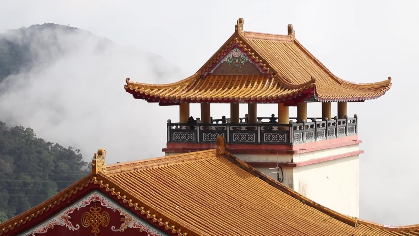Slow panning view of Ancient Chinese Chin Swee Caves Temple, Genting Highlands on top of misty mountain