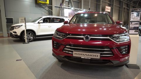 PRAGUE, CZECH REPUBLIC - AUGUST 28, 2020: Front view of a red SsangYong Korando at a car exhibition - a SsangYong Rexton in the background