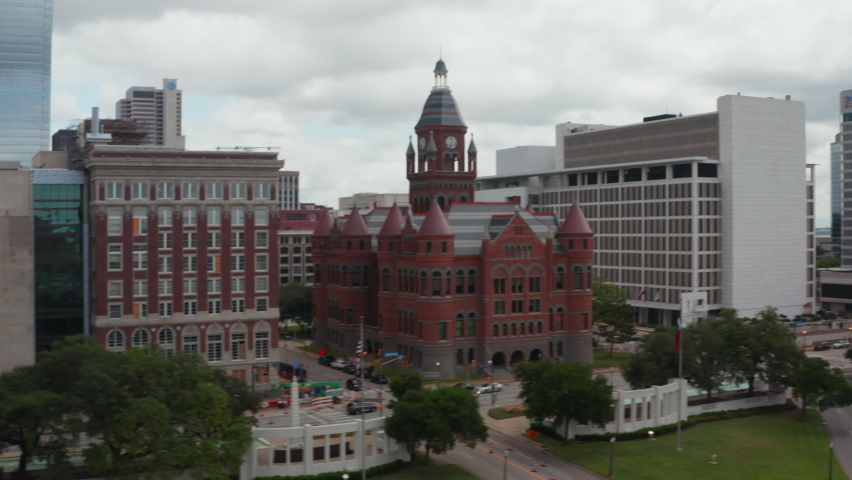 Aerial view of building in historic castle style with tower and few turrets. Old Red Museum of Dallas County between modern multi-storey office blocks downtown. Dallas, Texas, US