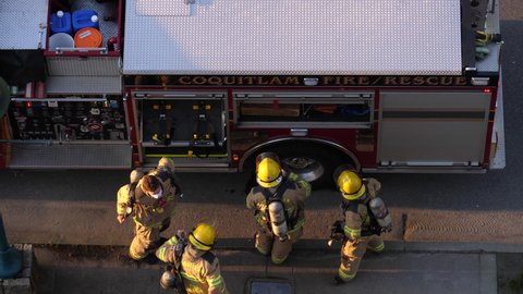 Coquitlam, BC, Canada - March 29, 2021 : Top shot of Coquitlam fire emergency personnel in rescue action. Police, fire, and ambulance vehicles stopping at road 