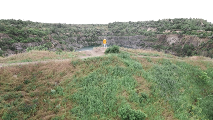 woman hiker enjoying view of old flooded mine blue water from above