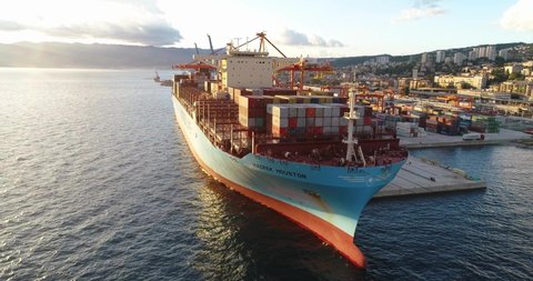 Rijeka , Croatia - 01 20 2021: Aerial shot of large international container cargo ship in port 