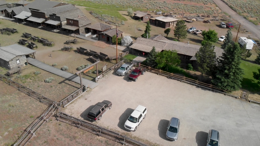 Slow upward aerial tilt of the Old Trail Town western scene in northern Wyoming during the summer.