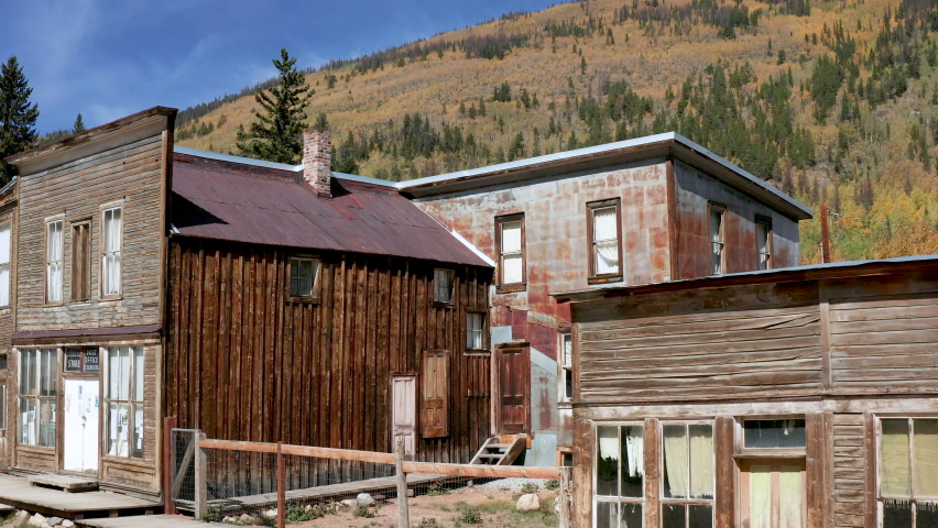 drone aerial shot of old west buildings in a ghost town in the mountains. Royalty-Free Stock Footage #1074123956