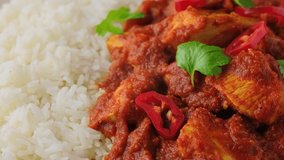 Spicy Chicken Pathia curry with basmati rice in a white plate. healthy food. rotating video