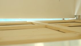 Horizontally flat panning shot of a wooden framework of an RV loft. Panning video of wooden planks.