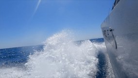 Bow wave of boat on sea in slow motion. Moving, travel, going, speed.
