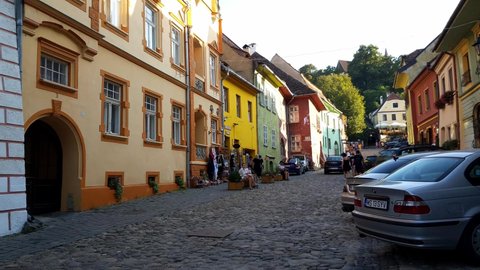 Sighisoara , Romania - 08 29 2020: People Sitting And Walking On A Cobblestone Street In The Historical Center Of Sighisoara