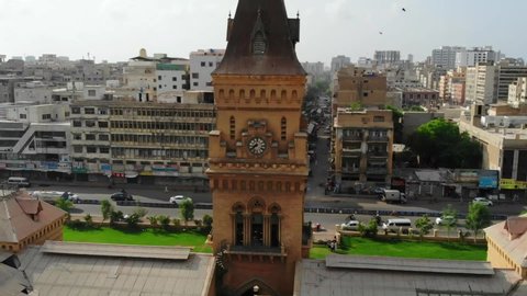 karachi , Pakistan - 05 03 2021: Aerial View Of Clock Tower At Empress Market. With Traffic Going Past In Background. Follow Shot