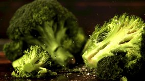 Super slow motion on the pieces of broccoli drop water droplets. Against a dark background.Filmed at 1000 fps.  - Powered by Shutterstock - Get 15% off with code: PIKWIZARD15