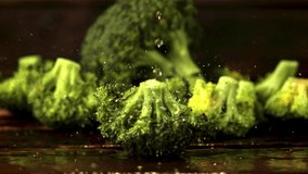 Super slow motion on broccoli drops drops water. Against a dark background. Filmed on a high-speed camera at 1000 fps. - Powered by Shutterstock - Get 15% off with code: PIKWIZARD15