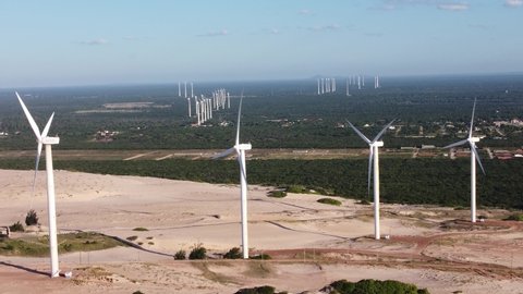 Aeolian wind farm park panorama at paradise beach. Green energy. Alterantive energy. Tropical travel destinations in Brazil, state of Ceará. Aeolian park wind farm turbines. Power plant green energy.