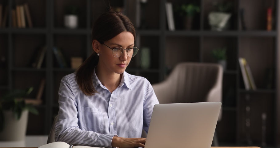 Businesswoman finish working on laptop put hands behind head lean on comfy ergonomics office chair for productive workday, spine in right position, good posture. Fruitful work accomplishment concept Royalty-Free Stock Footage #1074180533