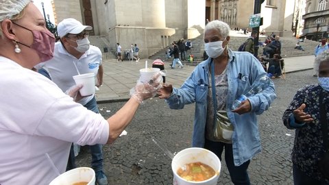 São Paulo, São Paulo, Brazil - 06 12 2021: volunteers donating meals to homeless people at Praça da Sé