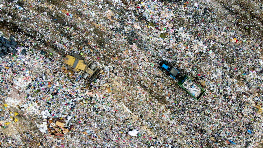 Landfill Dozer during working rubbish at garbage. Waste conservation. Trash disposal on rubbish dump. Arial view of landfill with plastic bags and food waste. Bulldozer on cleaning garbage. Trash
 Royalty-Free Stock Footage #1074200819