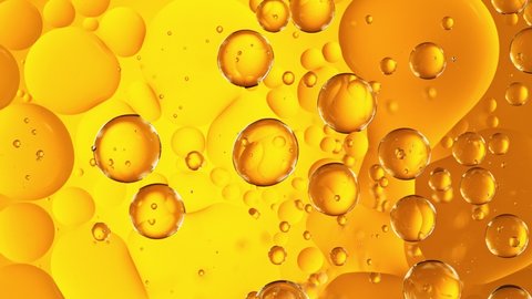 Super Slow Motion Shot of Moving Oil Bubbles on Golden Background at 1000fps.