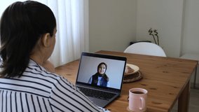 Women waving to each other in conversation with online camera. A woman making a video call with her friend from her home. Two friends with a new generation video chat.