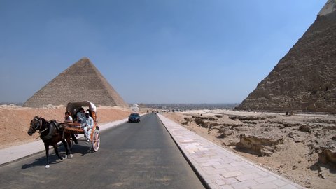 Giza, Egypt - 15 September, 2019: Horse-drawn carriages riding on Giza plateau