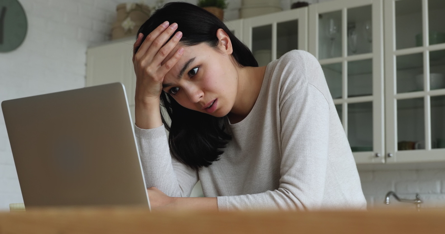 Young Asian woman read bad news on laptop look desperate, feels stressed due unsaved document, important data loss, notice form bank about debt, device malware, file error, work down the drain concept Royalty-Free Stock Footage #1074212429