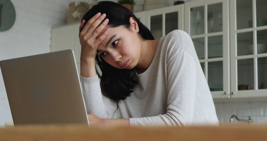 Young Asian woman read bad news on laptop look desperate, feels stressed due unsaved document, important data loss, notice form bank about debt, device malware, file error, work down the drain concept | Shutterstock HD Video #1074212429