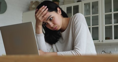 Young Asian woman read bad news on laptop look desperate, feels stressed due unsaved document, important data loss, notice form bank about debt, device malware, file error, work down the drain concept