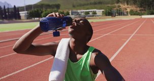 Animation of digital data processing over male athlete drinking water. global sports, competition and digital interface concept digitally generated video.