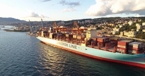 Rijeka , Croatia - 01 20 2021: Sweeping drone shot of large cargo ship in port 