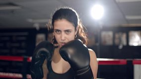 Fighter woman fist close up - boxer strikes into the side of the camcorder. Spectator video boxing.