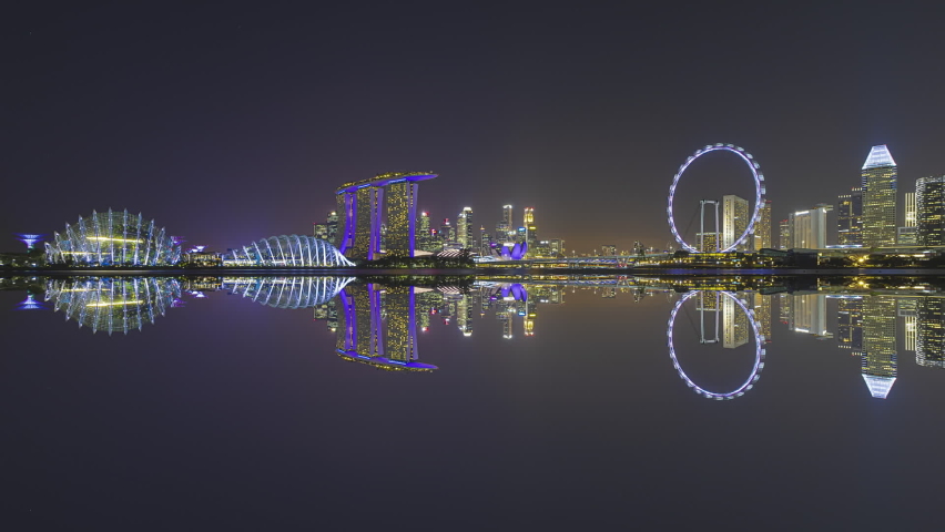 Beautiful Time lapse of Night to Day of Singapore skyline with reflection. Sunrise. Prores. Pan up motion timelapse. 4K available. Royalty-Free Stock Footage #1074223415