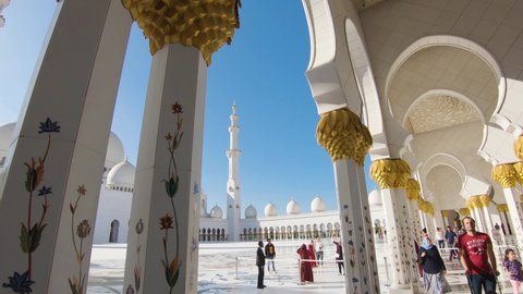 Abu Dhabi , United Arab Emirates - 01 13 2020: Visitors at Inner courtyard Sheikh Zayed Grand Mosque, Abu Dhabi, United Arab E