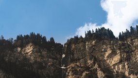 4K timelapse of clouds moving over snow mountains on a sunny day in Manali, Kullu, Himachal Pradesh Tourism, India