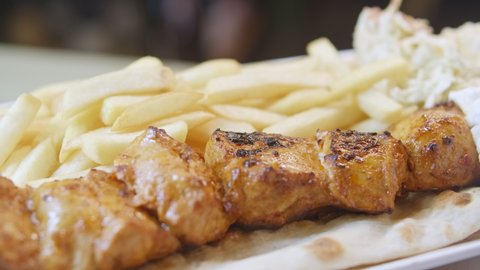Chicken Tawouk skewers and French fries  in the plate 