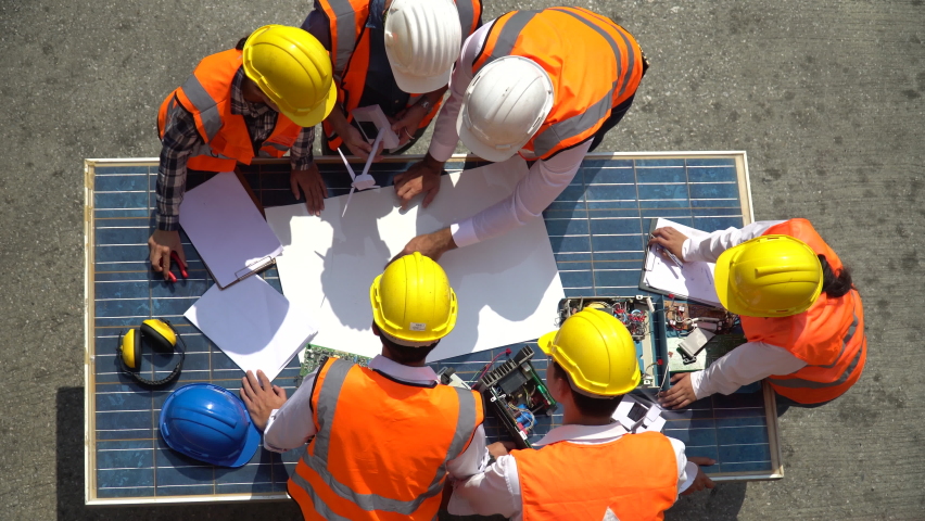 Group of Solar power plant Engineers Team Meeting and discussion to brainstorming with blueprint on solar cell top table Planning for a New Project of Environmental Power at construction site outdoors Royalty-Free Stock Footage #1074247769