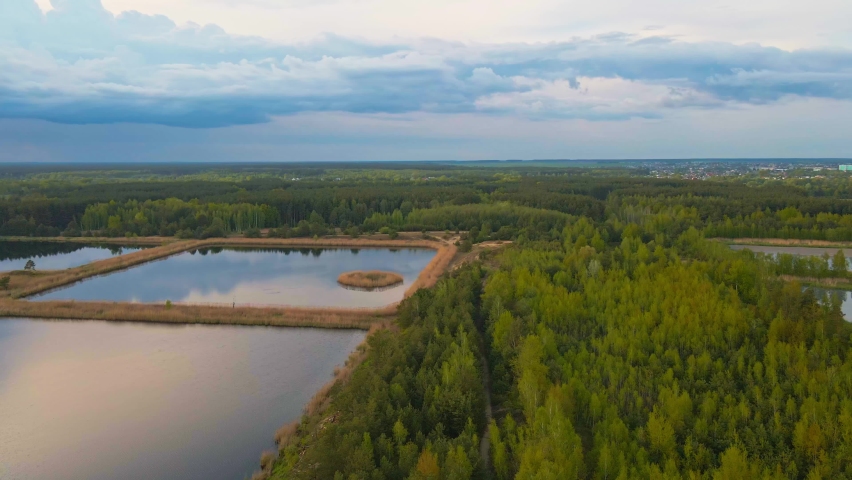 Aerial view of ponds for collect stormwater. Rainwater retention basins, bird eye view. Artifical pools for irrigation system