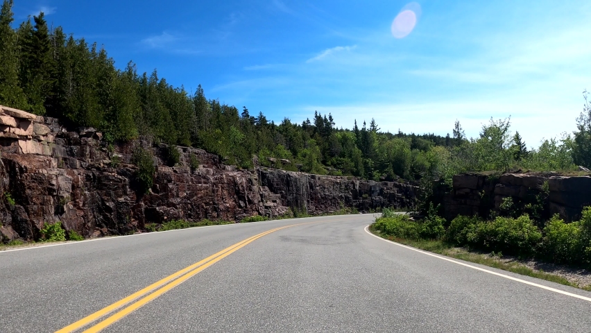 
4K POV point of view vehicle downhilll scenic driving the Cadillac Mountain curly road on early summer (part2). Car travel to the Acadia National Park, Maine, USA-Jun 3, 2021