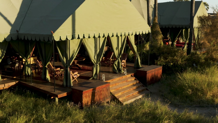 Aerial zoom out view of the beautiful tented safari lodge Jack's Camp on the Makgadikgadi Pans, Botswana Royalty-Free Stock Footage #1074250229