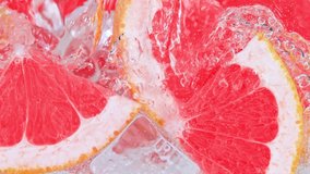 Super Slow Motion Shot of Pouring Water on Grapefruit Slices and Ice Cubes in Glass . - Powered by Shutterstock - Get 15% off with code: PIKWIZARD15