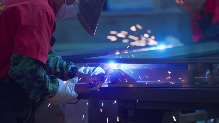 Close up of Blacksmith welding worker working in the factory Welding work sparks splashing | Shutterstock HD Video #1074250343