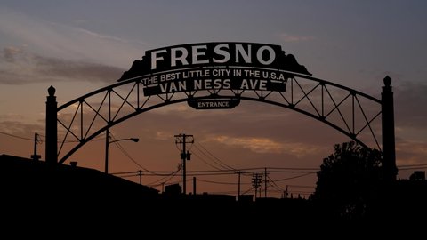 Fresno Archway Sign, Time Lapse at Sunrise with Colorful Clouds, California. USA