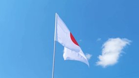 Japn. National country flag on blue sky background. Flying fabric symbol. Tourism or travel summer day. international patriotic emblem. Nobody. Horizontal video