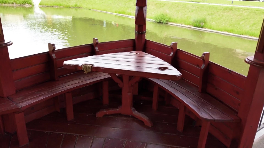 Wooden gazebo in the middle of the lake.