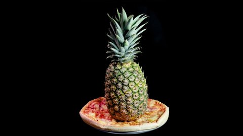 Whole pineapple on a hawaiian pizza spinning around. it's always a source of heated debate weather pineapple should go on pizza or no