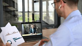 Online video communication, brainstorm. Two successful business colleagues communicate remotely via video conference, study financial graphs, discuss business strategy and a new project. Video call 