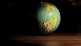 hand with globe on a table earth day with black background stock video stock footage